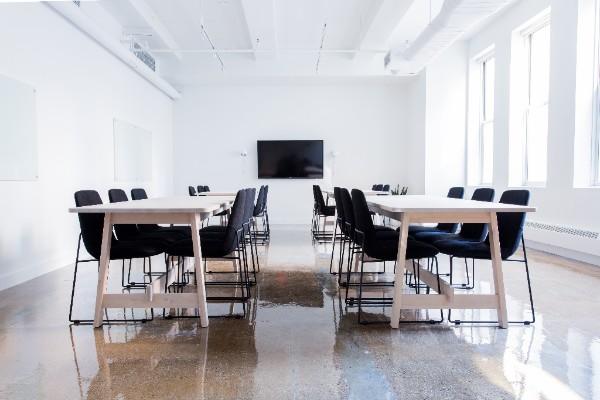 empty office with big conference style tables and black chairs