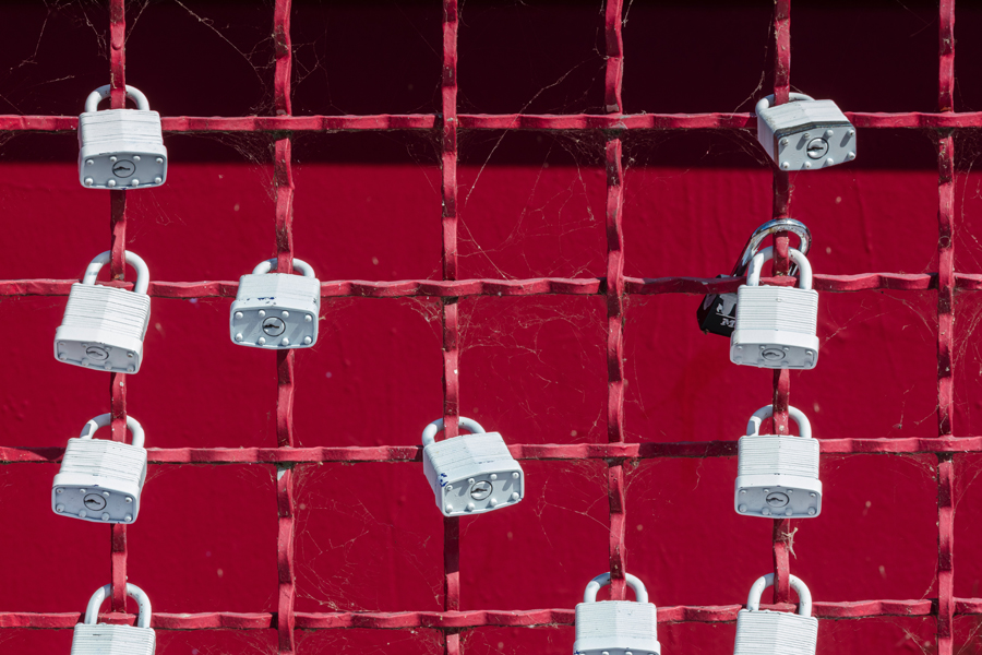padlocks on a red wire fence