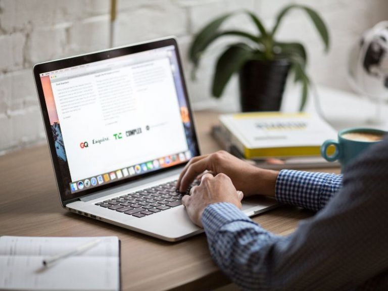 man reading an email on a laptop