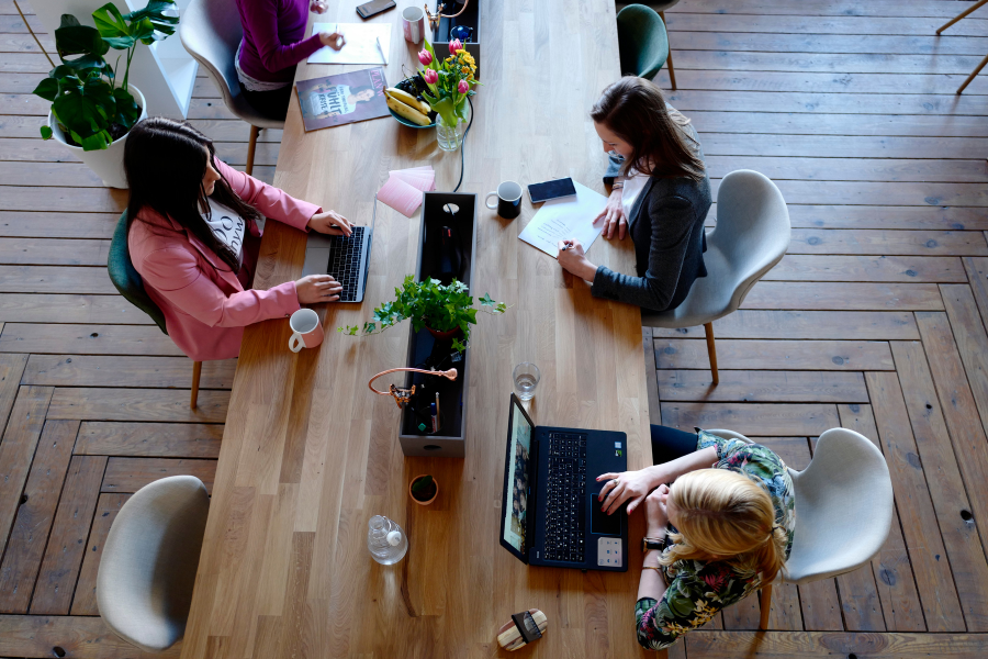 bird's eye view of 3 people co-working on the same table