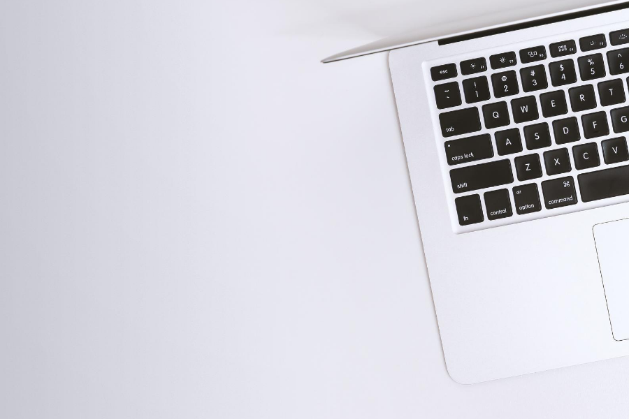 grey table top with a mac on it