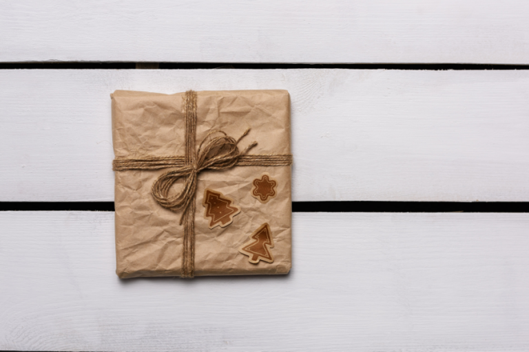 Christmas shopping online - a box in a brown present paper on white background